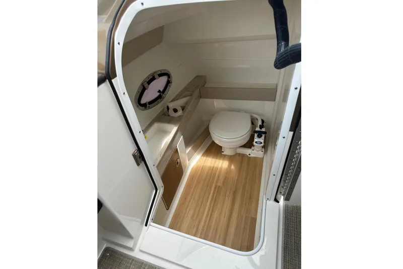 Slide: The Image of Interior of a 2018 Formula 290 Bowrider featuring a toilet and wood flooring. - 14