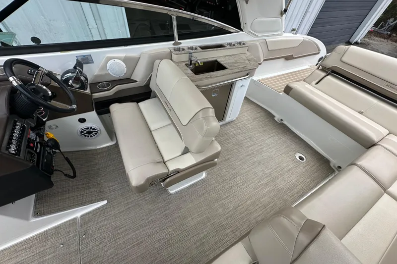 Slide: The Image of Interior of a 2018 Formula 290 Bowrider boat with beige seating and steering console. - 16