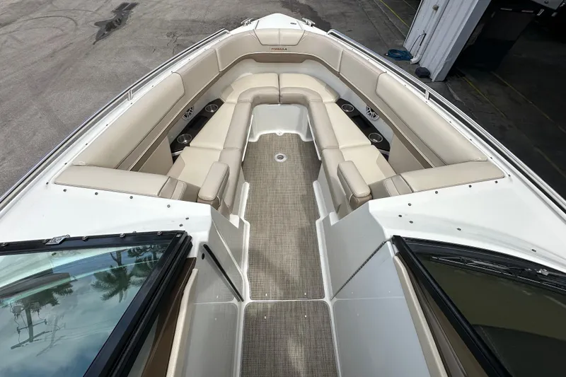 Slide: The Image of 2018 Formula 290 Bowrider boat interior with beige seating and cup holders. - 18