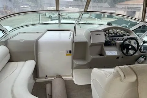 Slide: The Image of 2002 Cruisers Yachts 3372 Express cockpit with steering wheel and dashboard controls. - 5