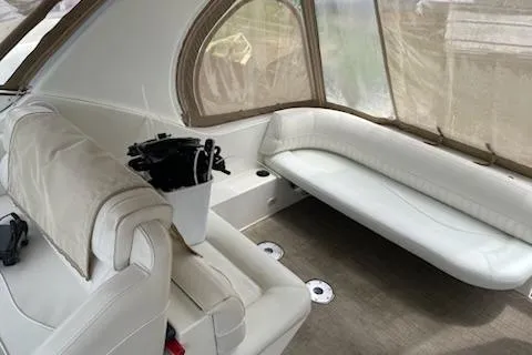 Slide: The Image of 2002 Cruisers Yachts 3372 Express interior with white seating and covered windows. - 7