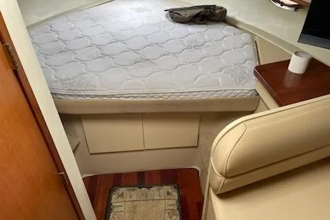 Slide: The Image of 2002 Cruisers Yachts 3372 Express cabin interior with bed and seating area. - 8