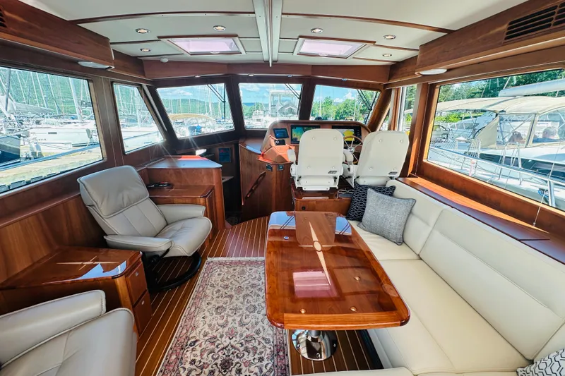 Slide: The Image of Luxurious interior of 2025 Sabre 48 Salon Express yacht with elegant seating and wood finishes. - 12