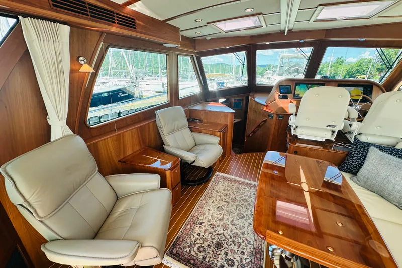 Slide: The Image of Luxurious interior of 2025 Sabre 48 Salon Express yacht with elegant seating and wood finishes. - 13