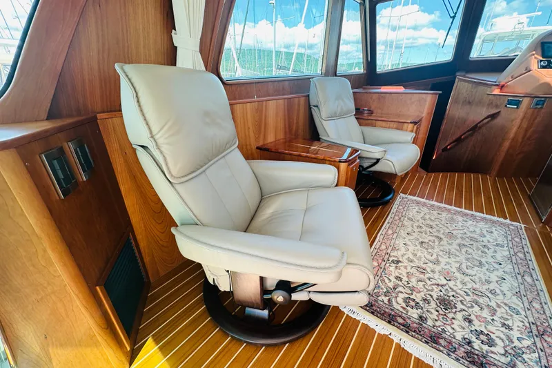 Slide: The Image of Luxurious interior of 2025 Sabre 48 Salon Express with leather seating and elegant wood finish. - 15