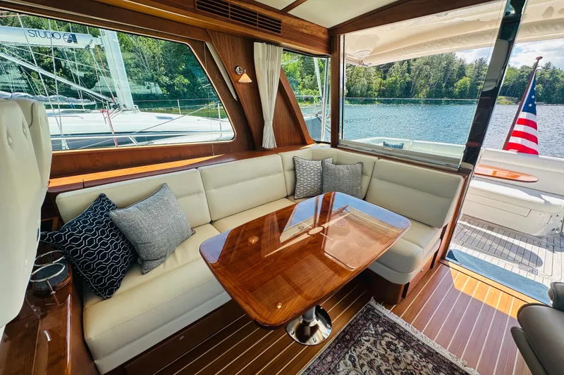 Slide: The Image of Interior of 2025 Sabre 48 Salon Express yacht with elegant seating and wooden table. - 19