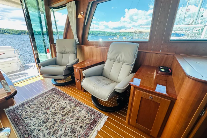 Slide: The Image of Luxurious interior of 2025 Sabre 48 Salon Express yacht with leather chairs and scenic view. - 22