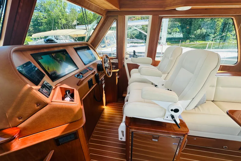 Slide: The Image of Interior of 2025 Sabre 48 Salon Express yacht with luxurious seating and advanced navigation displays. - 23
