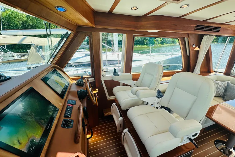 Slide: The Image of Interior of 2025 Sabre 48 Salon Express yacht with luxurious seating and navigation controls. - 24