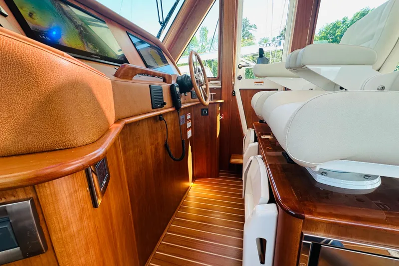 Slide: The Image of Interior of 2025 Sabre 48 Salon Express yacht with luxurious wood finish and modern controls. - 25