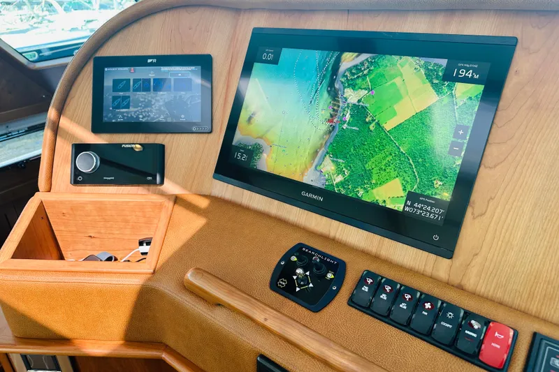 Slide: The Image of 2025 Sabre 48 Salon Express dashboard with Garmin navigation and control panels. - 27