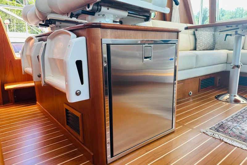 Slide: The Image of Interior of 2025 Sabre 48 Salon Express yacht with sleek wood finish and stainless steel fridge. - 30