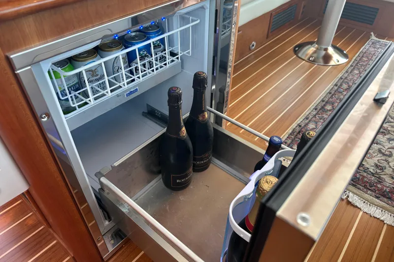 Slide: The Image of Mini fridge with drinks inside the 2025 Sabre 48 Salon Express yacht. - 31