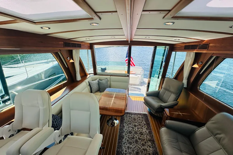 Slide: The Image of Luxurious interior of 2025 Sabre 48 Salon Express yacht with elegant seating and panoramic windows. - 32