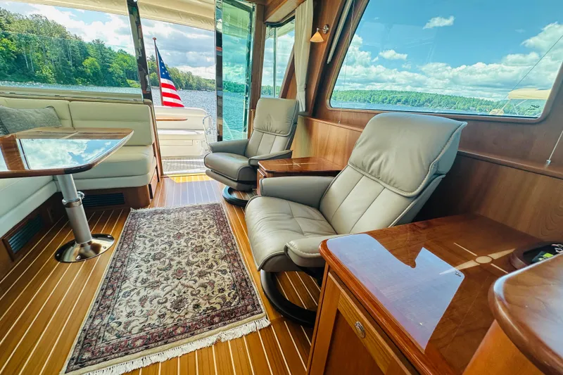 Slide: The Image of Luxurious interior of 2025 Sabre 48 Salon Express yacht with leather seating and scenic view. - 34
