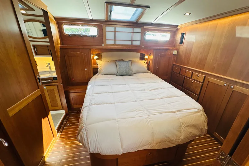 Slide: The Image of Luxurious bedroom interior of 2025 Sabre 48 Salon Express yacht with wood paneling. - 4
