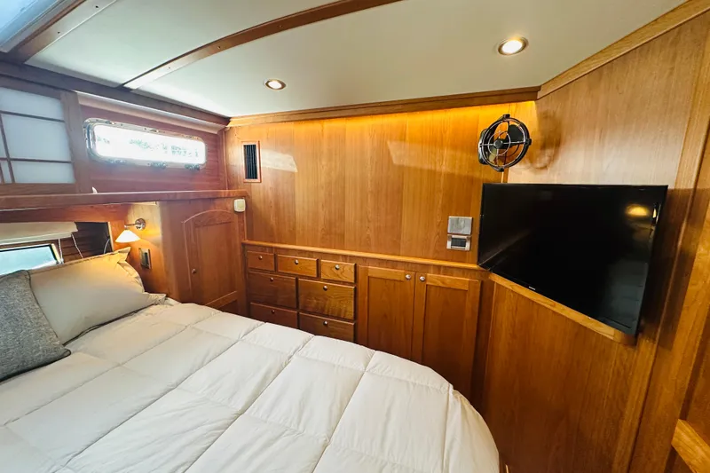 Slide: The Image of Luxurious 2025 Sabre 48 Salon Express cabin with wood paneling and modern amenities. - 44