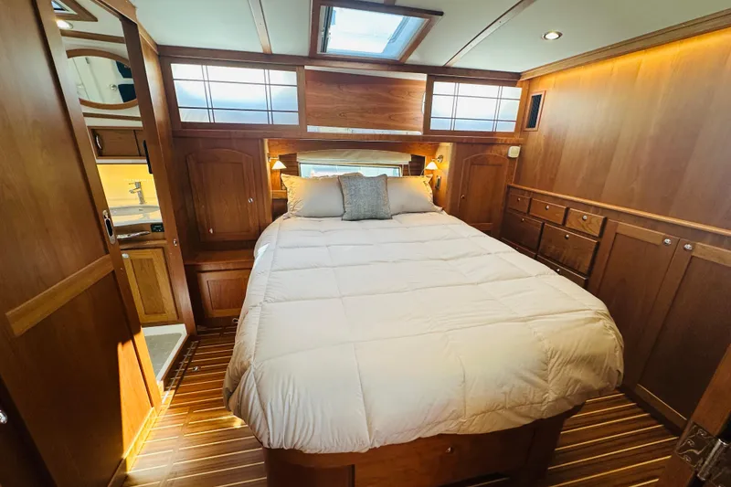 Slide: The Image of Luxurious bedroom interior of 2025 Sabre 48 Salon Express yacht with wood paneling. - 45