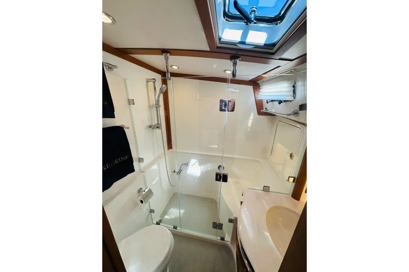 Slide: The Image of Modern bathroom interior of 2025 Sabre 48 Salon Express yacht, featuring sleek design and glass shower. - 51