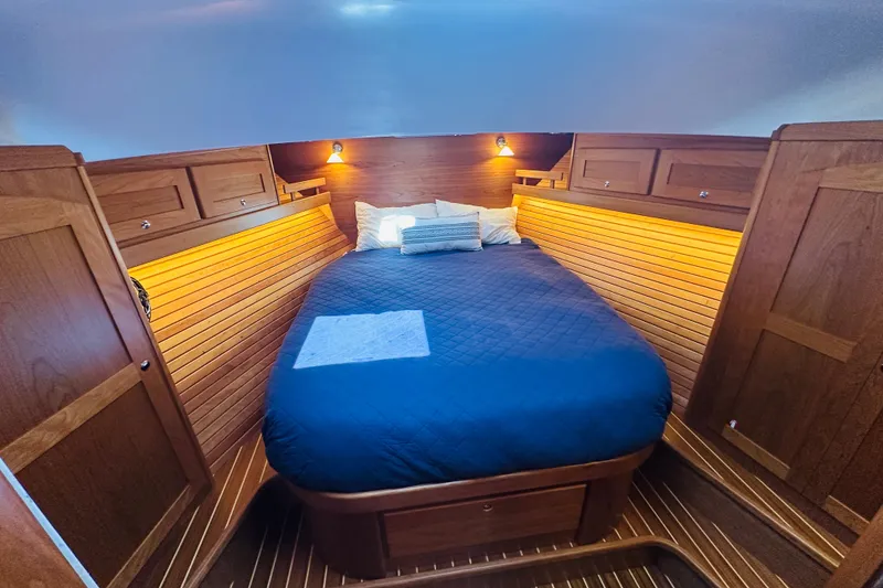 Slide: The Image of Luxurious cabin interior of 2025 Sabre 48 Salon Express with cozy bed and wooden finish. - 52