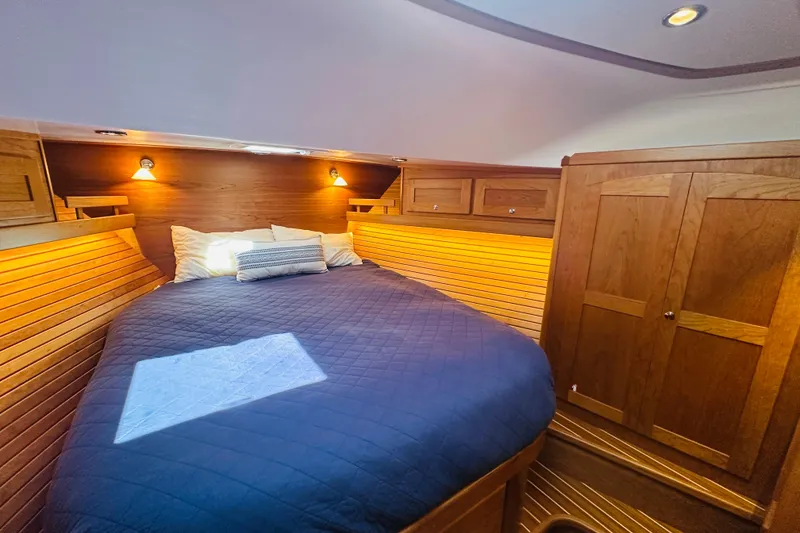 Slide: The Image of Cozy cabin interior of 2025 Sabre 48 Salon Express with wooden finishes and ambient lighting. - 53