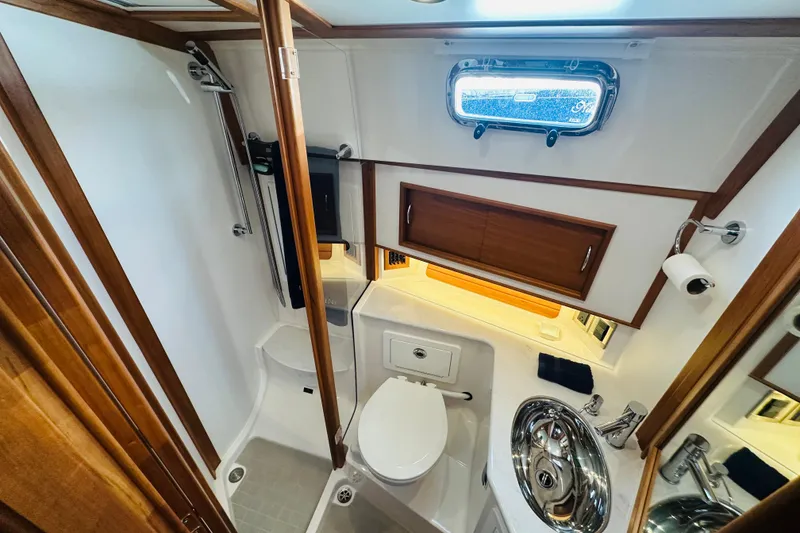 Slide: The Image of Luxurious bathroom in 2025 Sabre 48 Salon Express yacht, featuring modern fixtures and wood accents. - 56