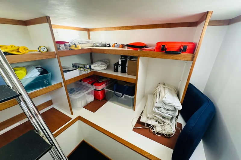 Slide: The Image of Storage area in 2025 Sabre 48 Salon Express yacht with organized shelves and equipment. - 63