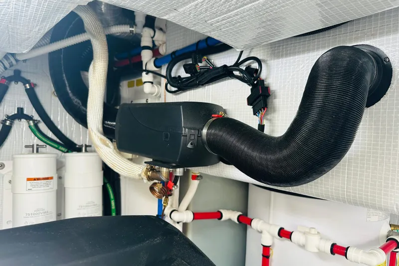 Slide: The Image of Engine room of 2025 Sabre 48 Salon Express with complex piping and wiring. - 70