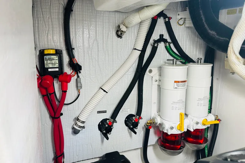 Slide: The Image of Engine room of 2025 Sabre 48 Salon Express with fuel filters and wiring. - 71