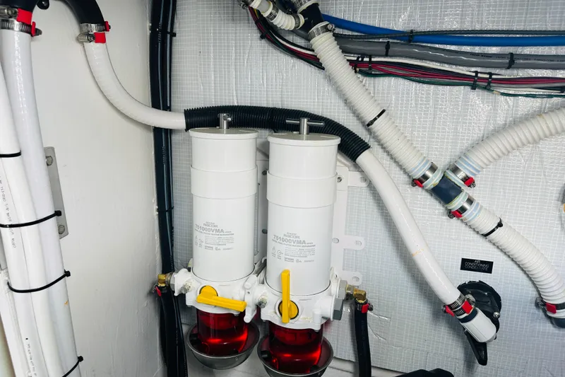Slide: The Image of Engine room of 2025 Sabre 48 Salon Express with fuel filters and hoses. - 72