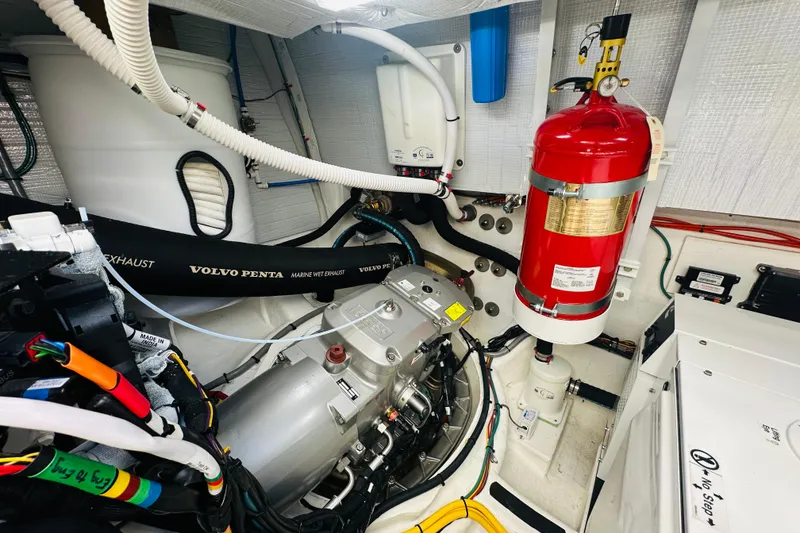 Slide: The Image of Engine room of 2025 Sabre 48 Salon Express with Volvo Penta components and fire extinguisher. - 75