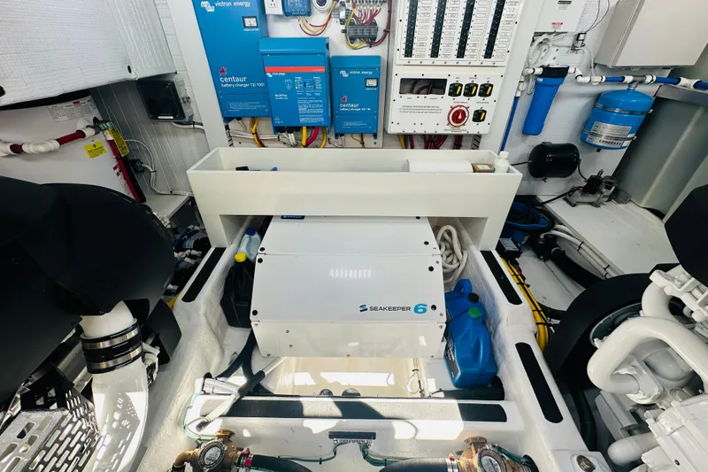 Slide: The Image of Engine room of 2025 Sabre 48 Salon Express with Seakeeper 6 stabilizer and electrical systems. - 80