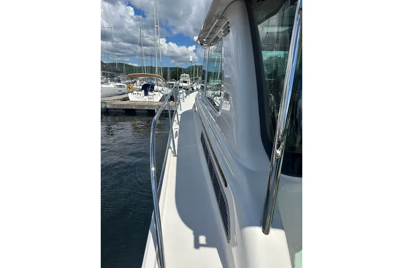 Slide: The Image of 2025 Sabre 48 Salon Express yacht docked, showcasing sleek design and polished railings. - 82