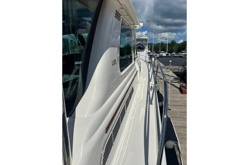 Slide: The Image of 2025 Sabre 48 Salon Express yacht docked, showcasing sleek design and polished exterior. - 83