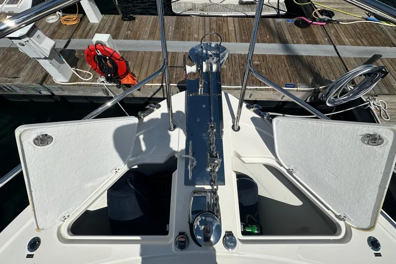 Slide: The Image of Bow view of 2025 Sabre 48 Salon Express yacht docked, showcasing open storage compartments. - 85