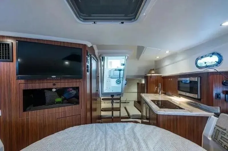 Slide: The Image of Luxurious interior of 2023 Pursuit OS 355 Offshore boat with modern amenities and wood finish. - 10
