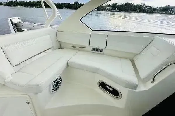 Slide: The Image of 2023 Pursuit OS 355 Offshore boat interior with white seating and water view. - 5