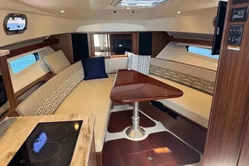 Slide: The Image of Luxurious interior of 2023 Pursuit OS 355 Offshore boat with elegant seating and dining area. - 8