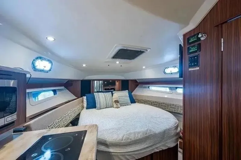 Slide: The Image of Luxurious cabin interior of 2023 Pursuit OS 355 Offshore boat with cozy bed and modern amenities. - 9