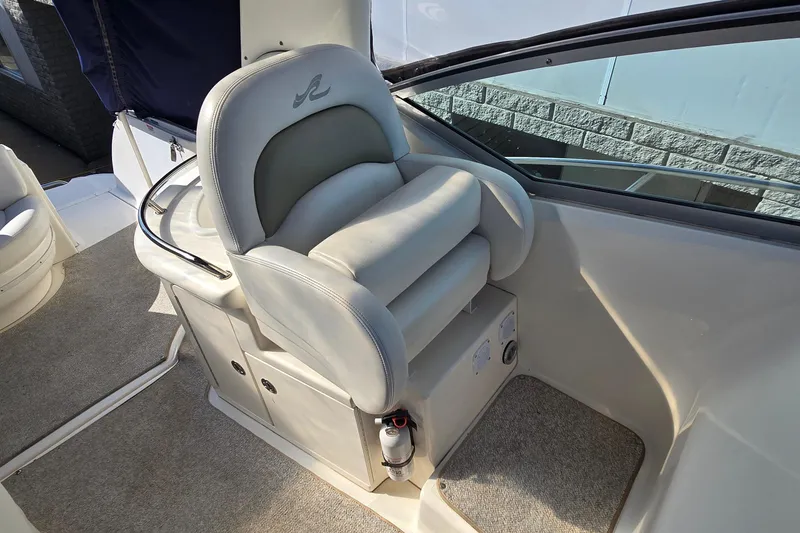 Slide: The Image of Captain's seat on a 2007 Sea Ray 340 Sundancer boat, featuring plush upholstery. - 11
