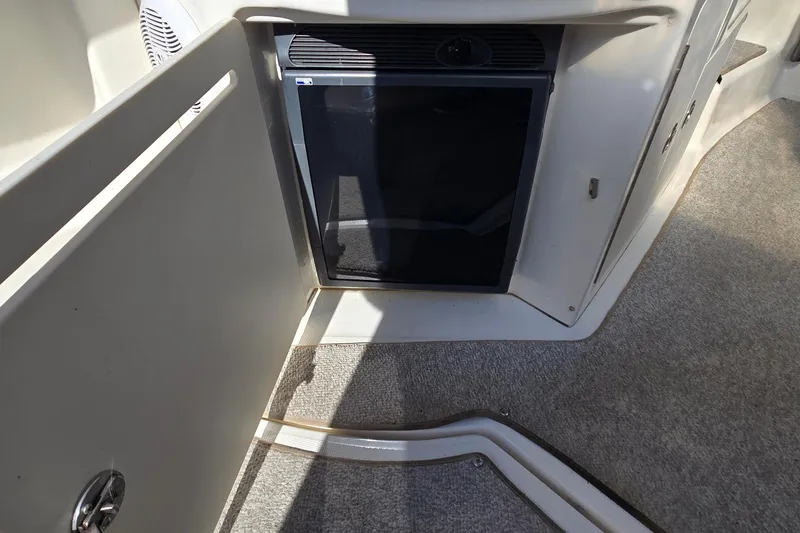 Slide: The Image of 2007 Sea Ray 340 Sundancer interior with mini fridge and carpeted flooring. - 12