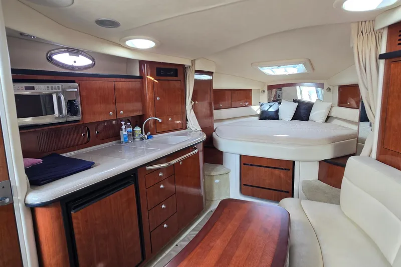 Slide: The Image of Luxurious interior of a 2007 Sea Ray 340 Sundancer yacht with kitchen and cozy sleeping area. - 15