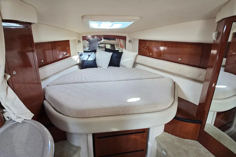 Slide: The Image of Luxurious cabin interior of 2007 Sea Ray 340 Sundancer with cozy bedding and wood accents. - 16