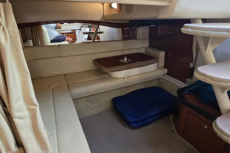 Slide: The Image of Interior of 2007 Sea Ray 340 Sundancer yacht with beige seating and compact dining area. - 18