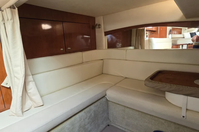 Slide: The Image of Interior of 2007 Sea Ray 340 Sundancer with cream leather seating and wooden cabinetry. - 19