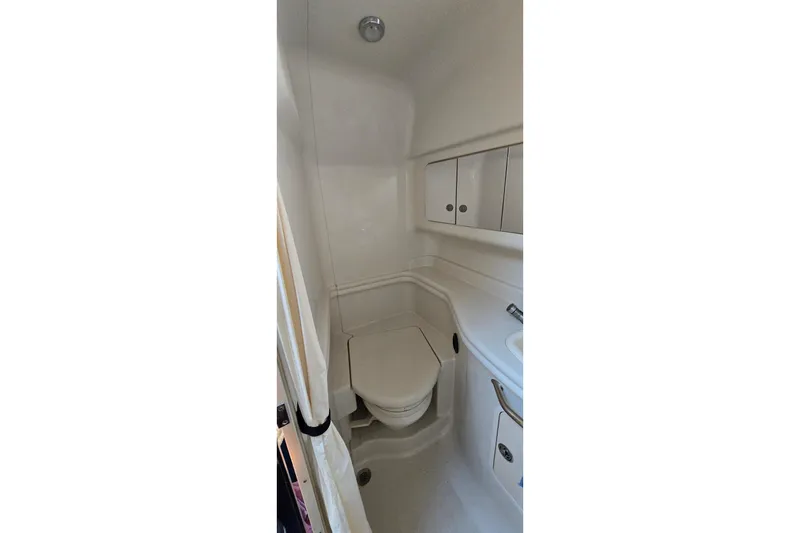 Slide: The Image of 2007 Sea Ray 340 Sundancer bathroom interior with compact design and white fixtures. - 20