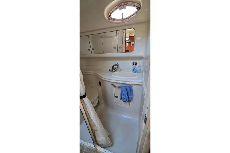 Slide: The Image of 2007 Sea Ray 340 Sundancer bathroom with sink, mirror, and storage cabinets. - 22