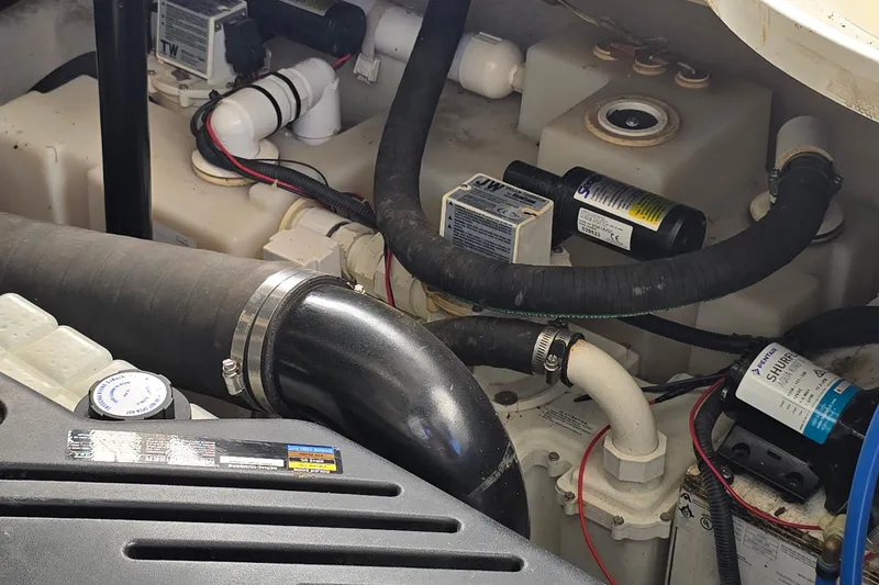 Slide: The Image of Engine compartment of a 2007 Sea Ray 340 Sundancer with hoses and components visible. - 29