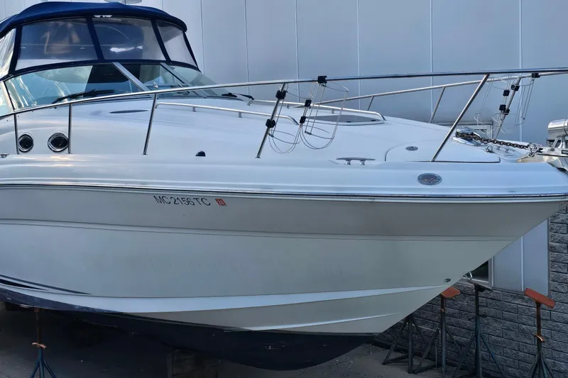 Slide: The Image of 2007 Sea Ray 340 Sundancer boat docked, featuring sleek white hull and blue canopy. - 3
