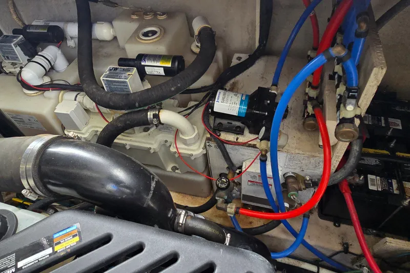 Slide: The Image of Engine compartment of a 2007 Sea Ray 340 Sundancer with visible hoses and wiring. - 31
